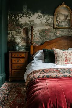 a bed in a bedroom with a painting on the wall behind it and a red bedspread