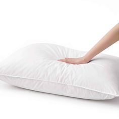 a person laying on a pillow with their hand on the pillow