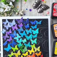 several different colored butterflies are on the table