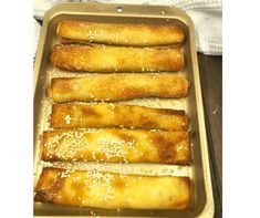 some bread sticks are in a baking pan