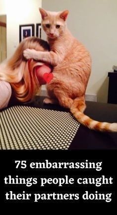 an orange cat sitting on top of a table next to a woman with long blonde hair
