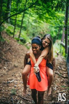 two girls in the woods hugging each other