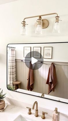 a bathroom mirror with towels hanging on it
