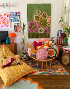 a living room filled with lots of colorful pillows