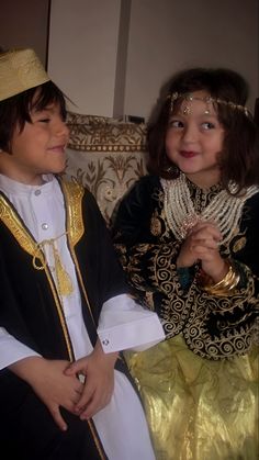 two children dressed in costumes sitting next to each other