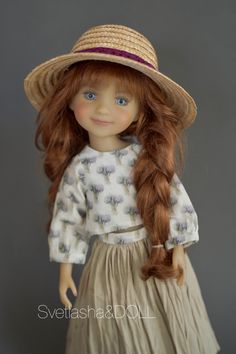 a doll with long red hair wearing a straw hat and dress, standing in front of a gray background