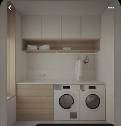 there is a washer and dryer in this small laundry room with white cabinets
