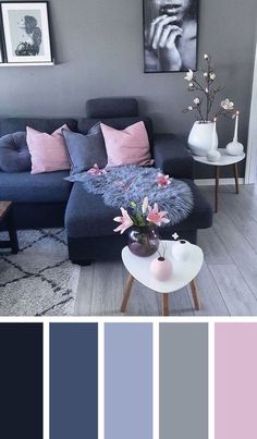 a living room with grey walls and pink pillows on the couch, gray rugs