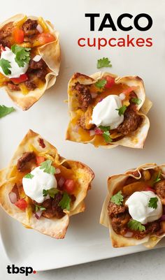 mini tacos with meat and sour cream on top are arranged on a white plate