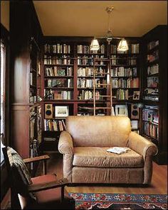 a living room filled with furniture and lots of bookshelves full of bookcases