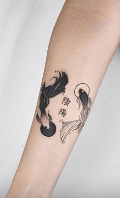 a woman's arm with a tattoo on it that has an image of two fish in the water