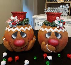 two decorated pumpkins sitting on top of a table