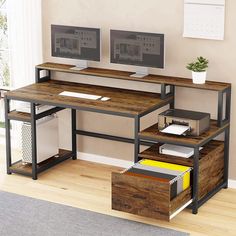 a computer desk with two monitors on top of it and some drawers underneath the desk