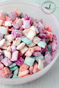 a bowl filled with colorful marshmallows on top of a table