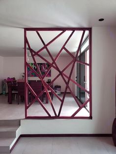 a mirror that is in the middle of a room with some stairs and tables behind it