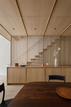 a dining room with wooden walls and stairs