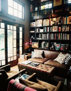 a living room filled with furniture and lots of books