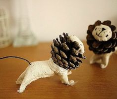 two small animals made out of pine cones on a table