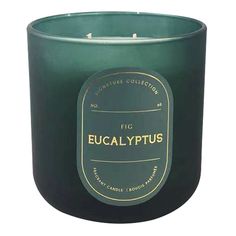 a candle that is green with gold lettering