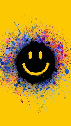 a smiley face with paint splatters around it on a yellow background and black circle