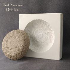 two decorative ceramic plates sitting next to each other on a white box with the words mold dimensionss 13 - 14cm