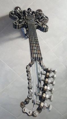 a metal contraption with lots of gears attached to it's sides on the floor