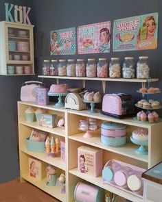 a room with shelves filled with cakes and cupcakes