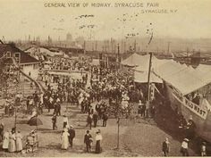 an old black and white photo of people at a fair