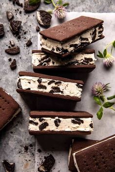 ice cream sandwiches with oreo cookies and mint sprinkles on a table