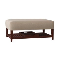 a footstool with a wooden shelf underneath it
