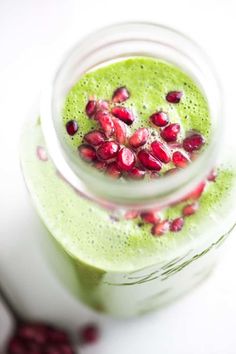 a green smoothie with pomegranates in it