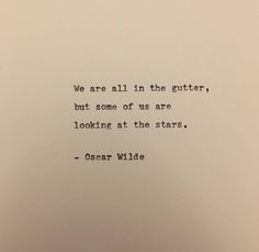 an old typewriter with the words we are all in the gutter, but some of us are looking at the stars