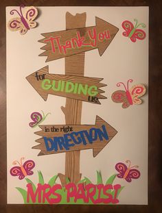 a wooden sign with butterflies on it and the words thank you for guiding in the right direction
