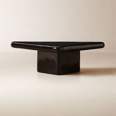 a black table sitting on top of a white floor