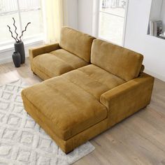 a large sectional couch sitting on top of a wooden floor