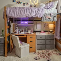a loft bed with desk underneath it and drawers below the bed is also a chair