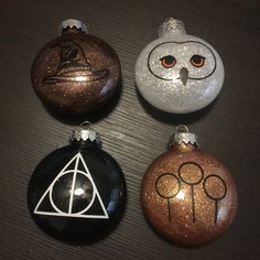 three harry potter christmas ornaments on a table