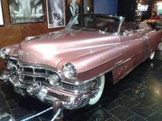 an antique car is on display in a museum