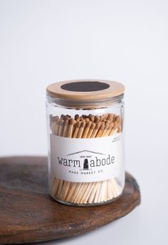 a jar filled with matches sitting on top of a wooden table
