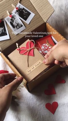 someone is opening a valentine's card in a box