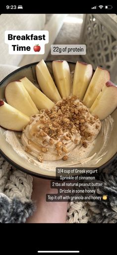 a bowl filled with oatmeal and sliced apples on top of a table