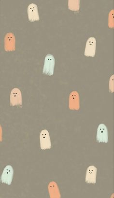 a group of small white and orange ghost like objects on a gray background with black dots