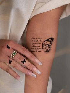 a woman with a butterfly tattoo on her arm