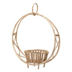 a basket hanging from the side of a white wall with a circular design on it