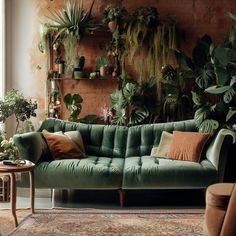 a living room filled with lots of green furniture and potted plants on the wall