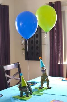 two birthday balloons are sitting on a table