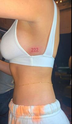 a woman's stomach with the number 22 on her left side and two small numbers on her right side