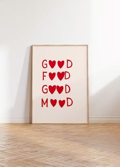 a red and white poster with hearts on it in front of a wall that says god, good, m & d