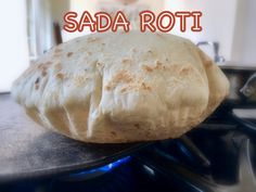 a close up of a bread on a stove with the words sada roti above it