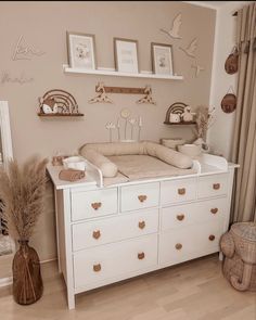a baby's room is decorated in neutral colors